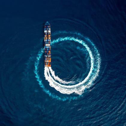 Container cargo ship going in circles